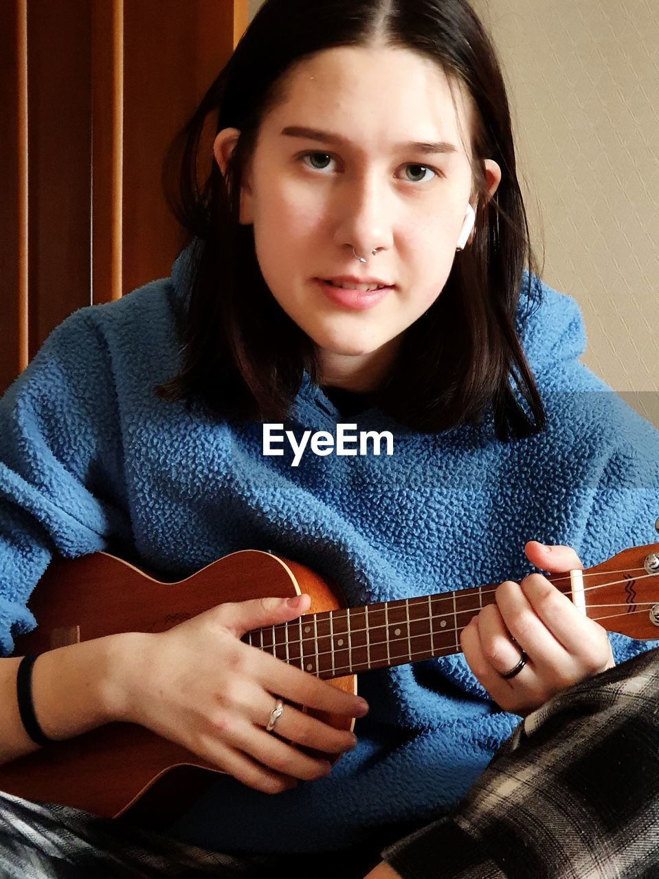 PORTRAIT OF A YOUNG WOMAN WITH GUITAR