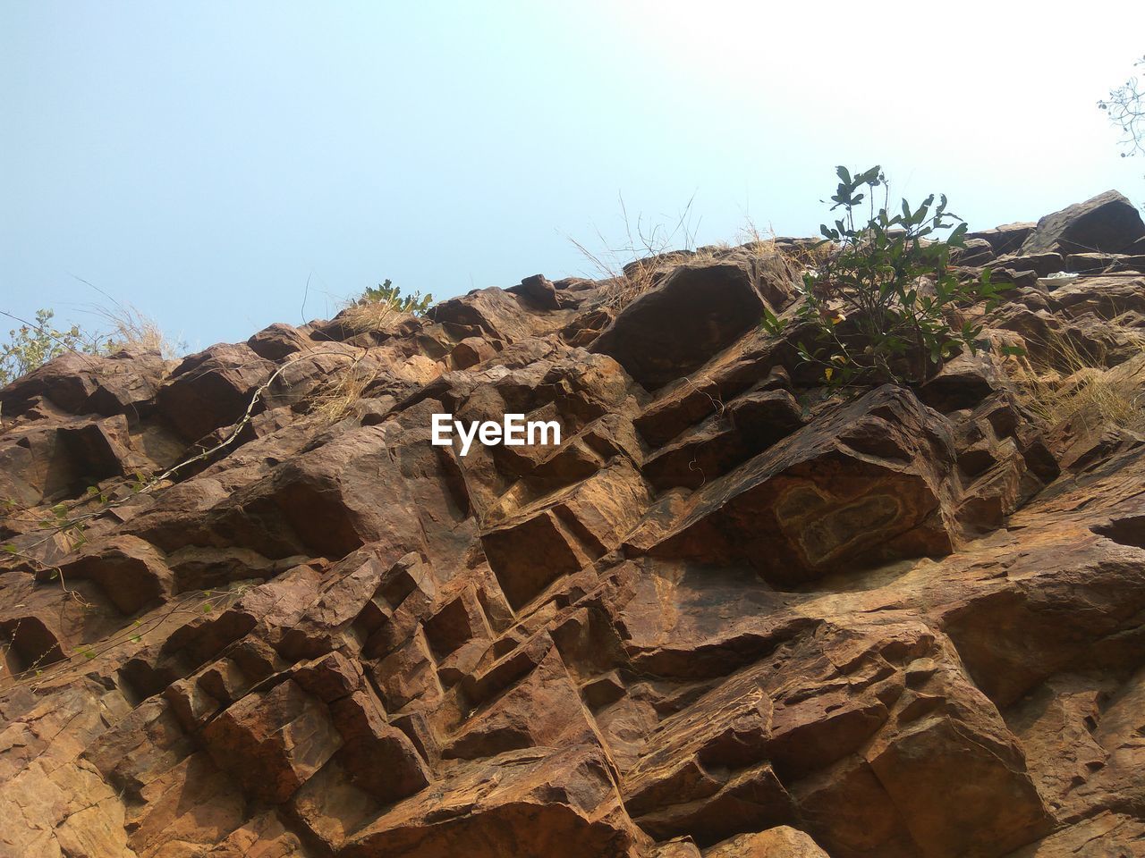 Low angle view of rocks against clear sky