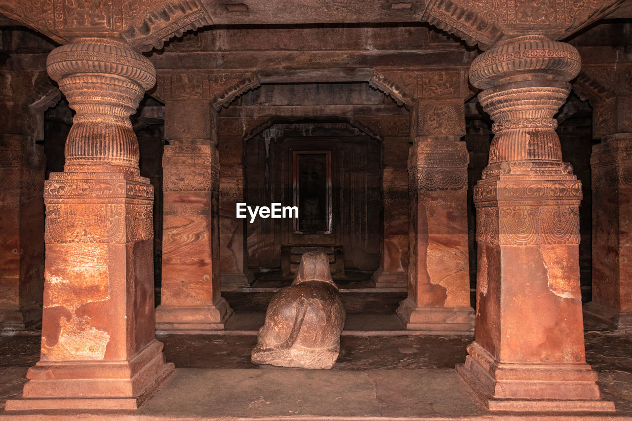 Badami cave sculptures of hindu gods carved on roof ancient stone art in details