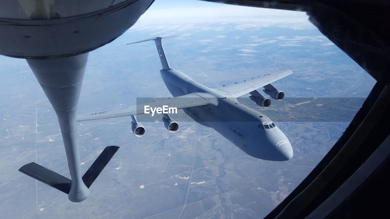 CROPPED IMAGE OF AIRPLANE WING OVER AIRPLANE