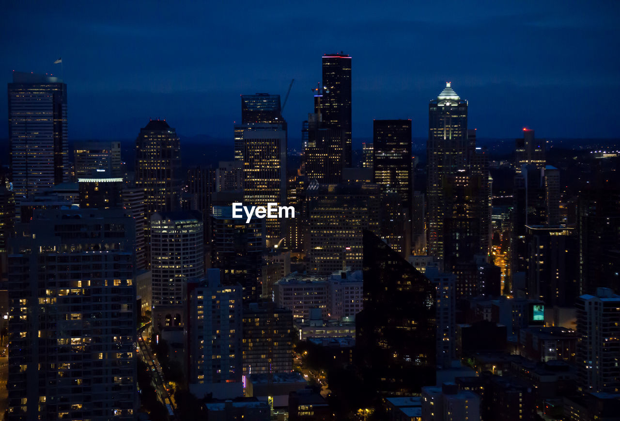 Aerial view of city lit up at night