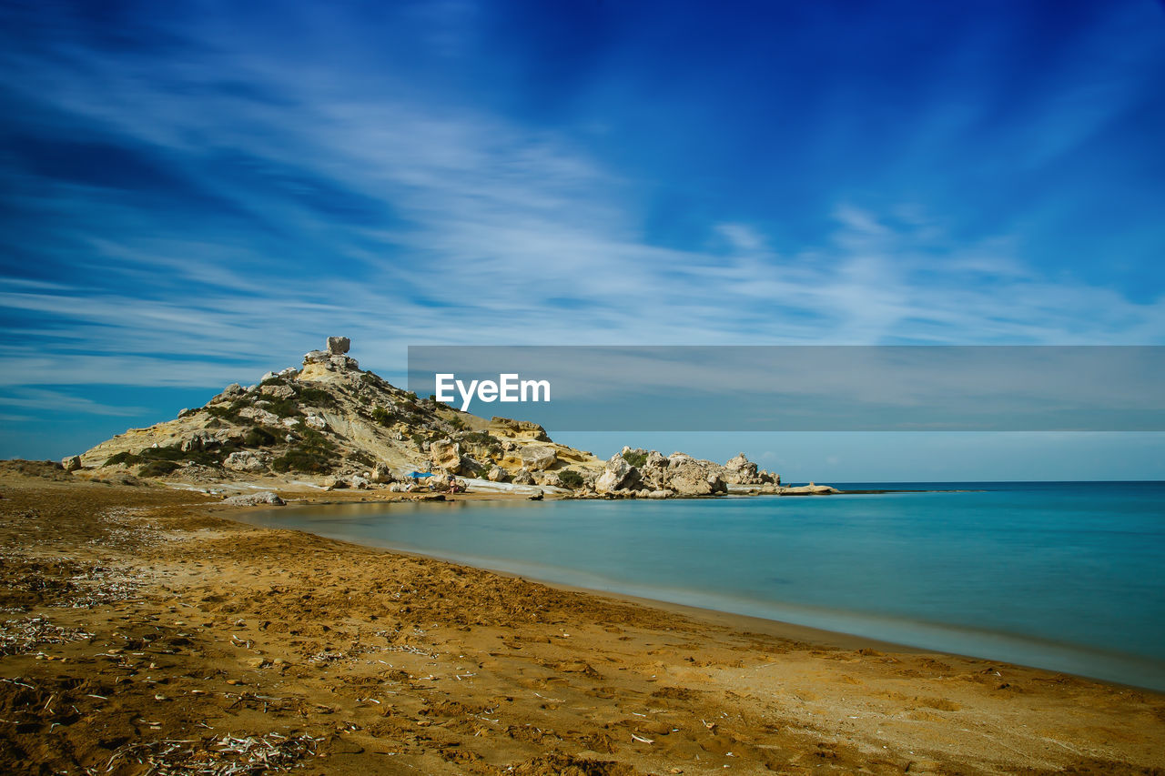 View of beach against cloudy sky