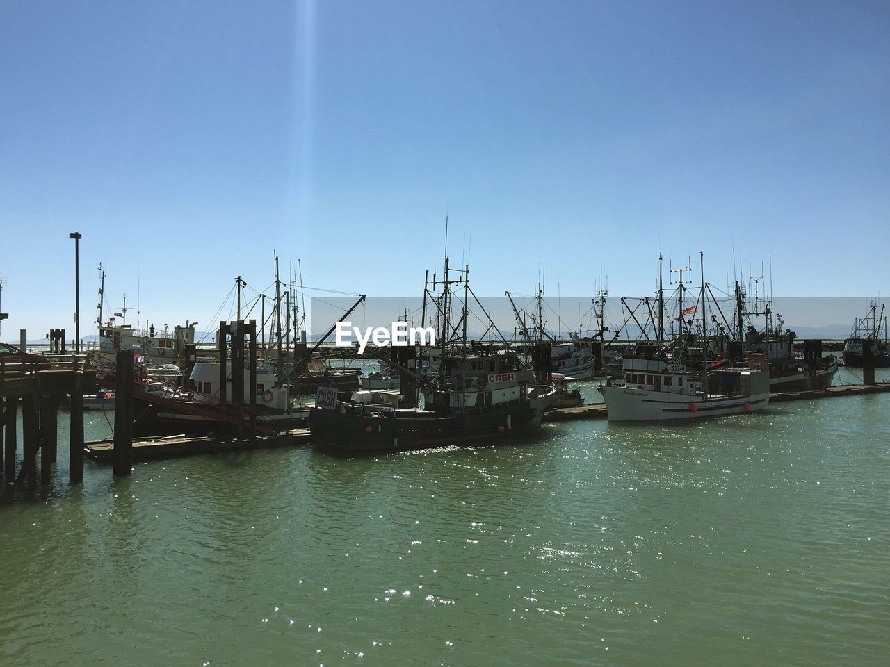 SAILBOATS MOORED IN HARBOR