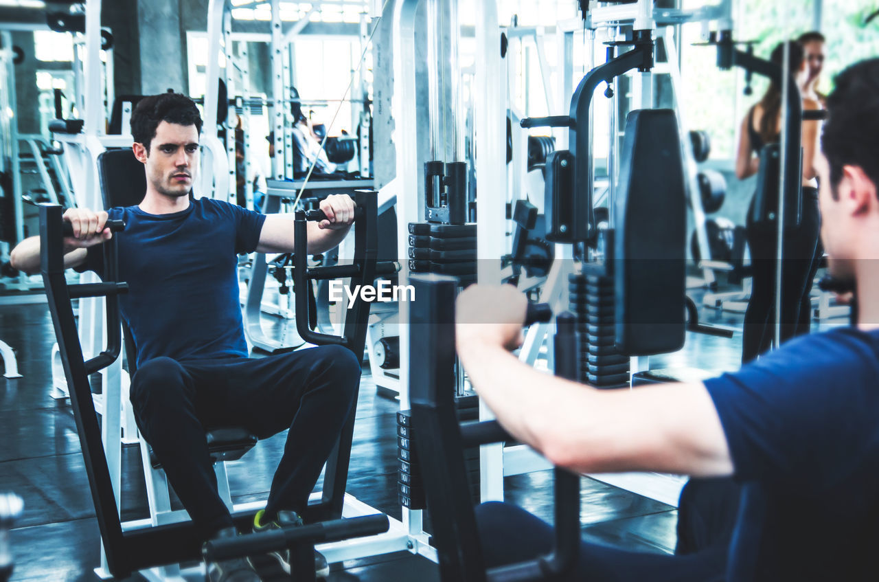 Young man exercising in gym