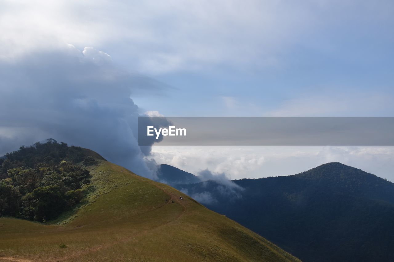 Scenic view of mountains against cloudy sky