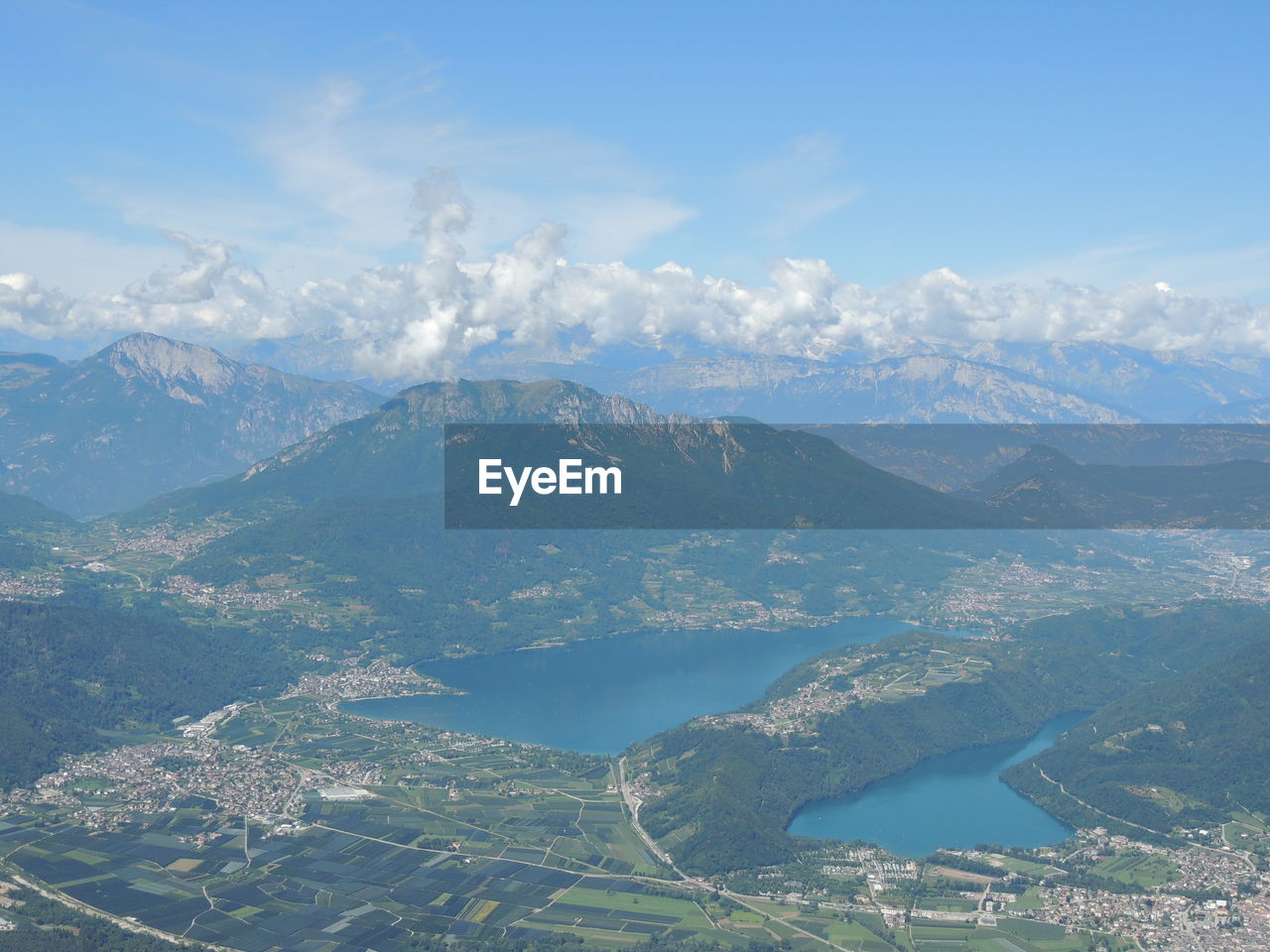 AERIAL VIEW OF CITY BY MOUNTAIN AGAINST SKY