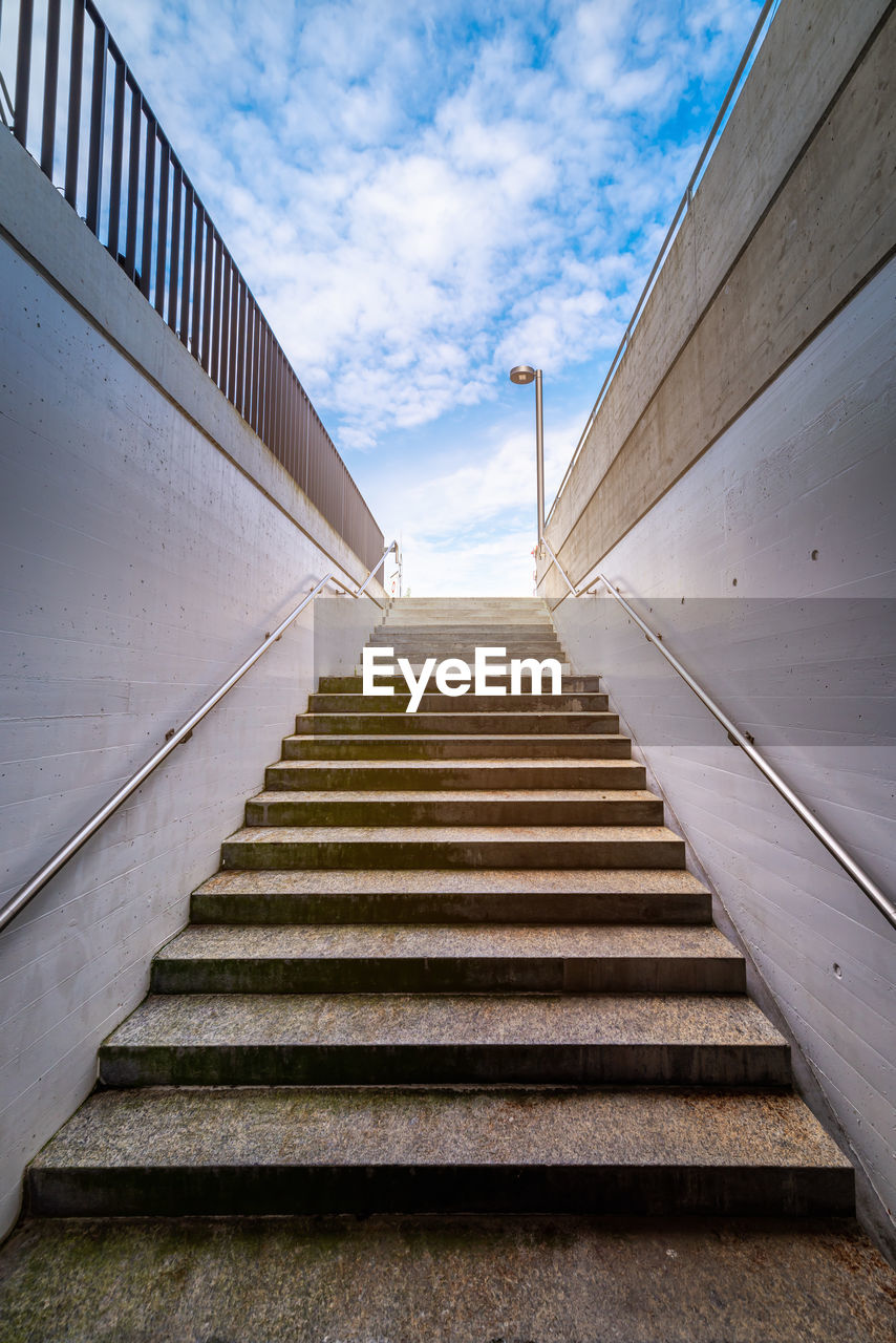 Low angle view of staircase by building against sky