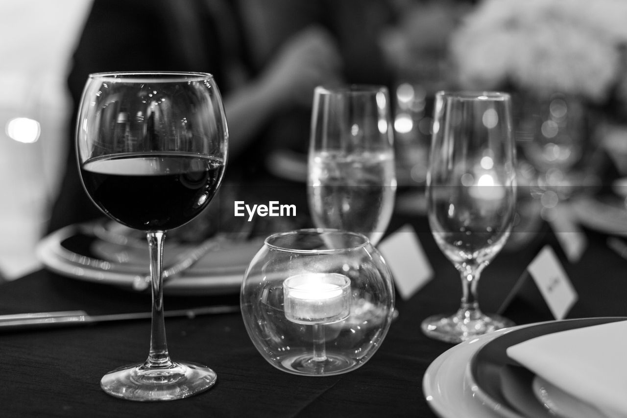 Close-up of wine glasses on table