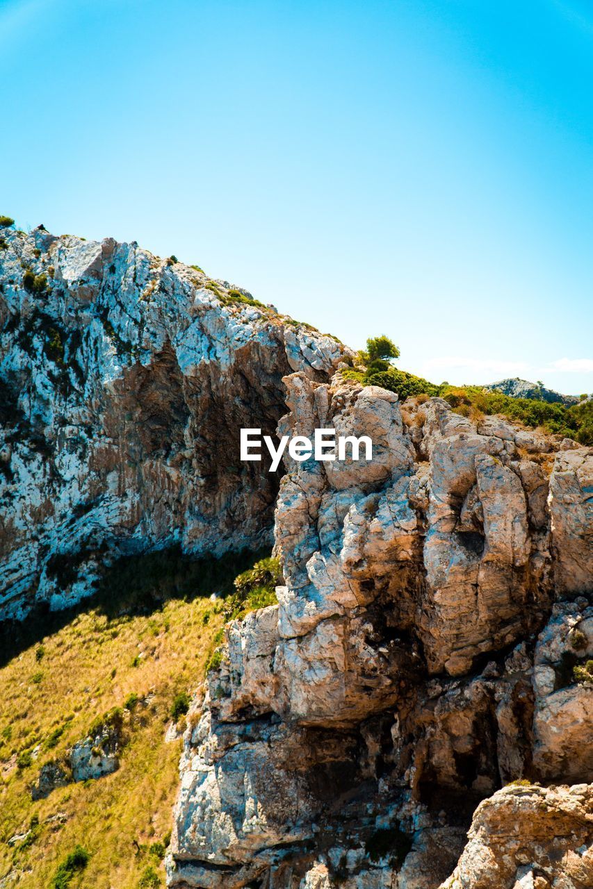 Scenic view of mountains against clear blue sky