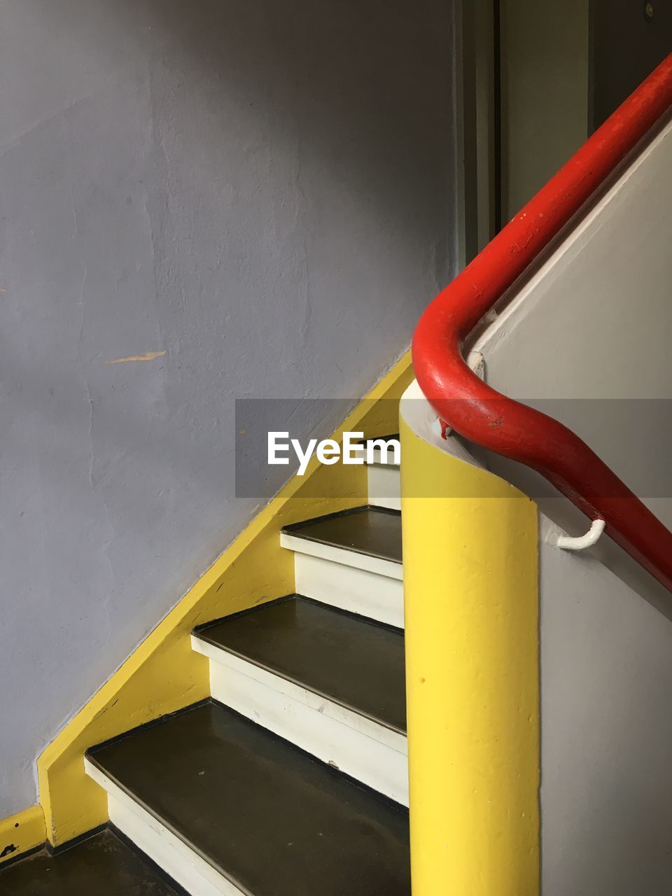 CLOSE-UP OF STEPS AND YELLOW RAILING