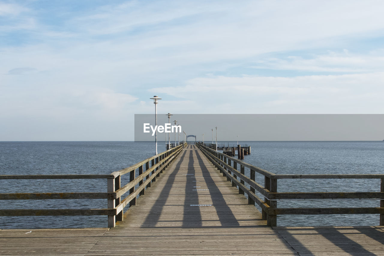 Pier over sea against sky