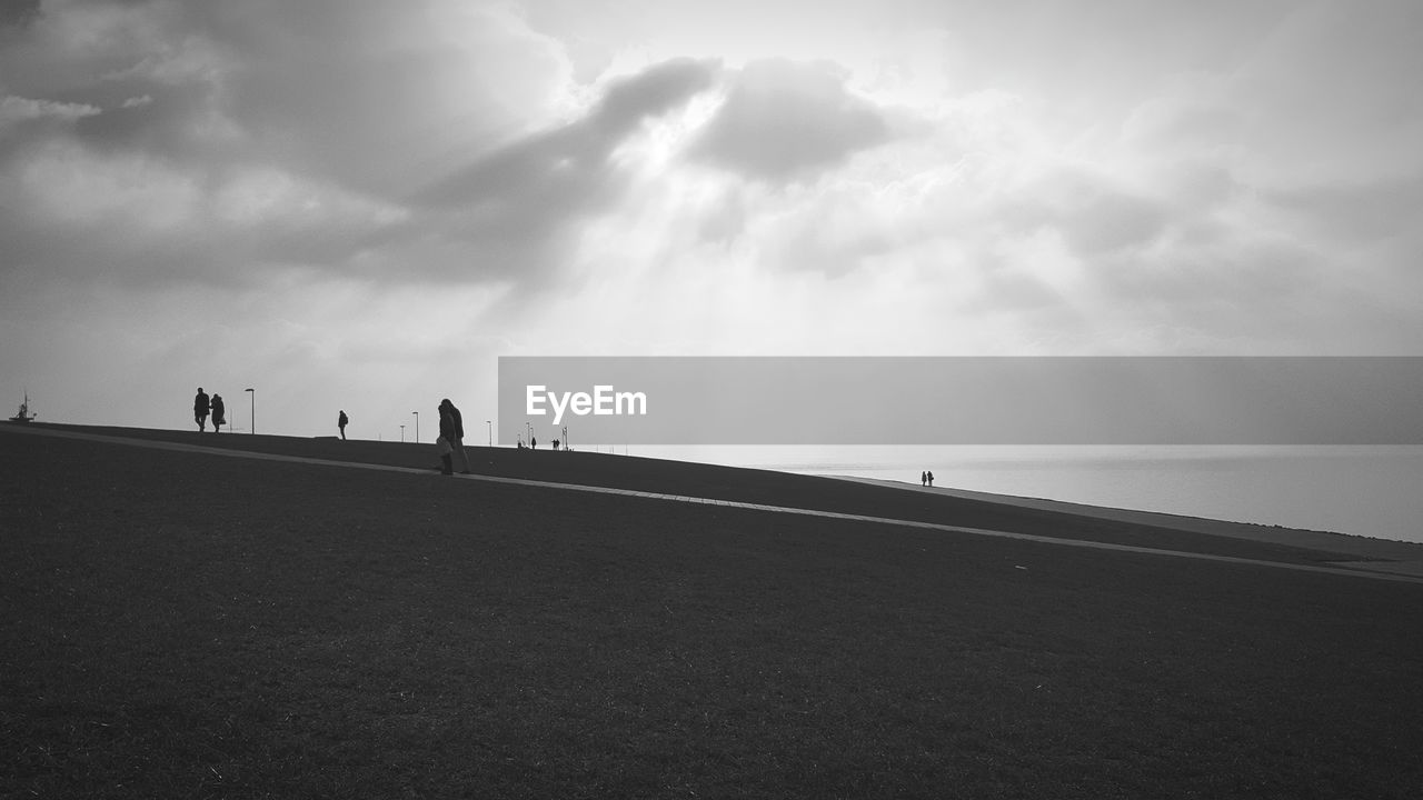 PEOPLE WALKING AT BEACH