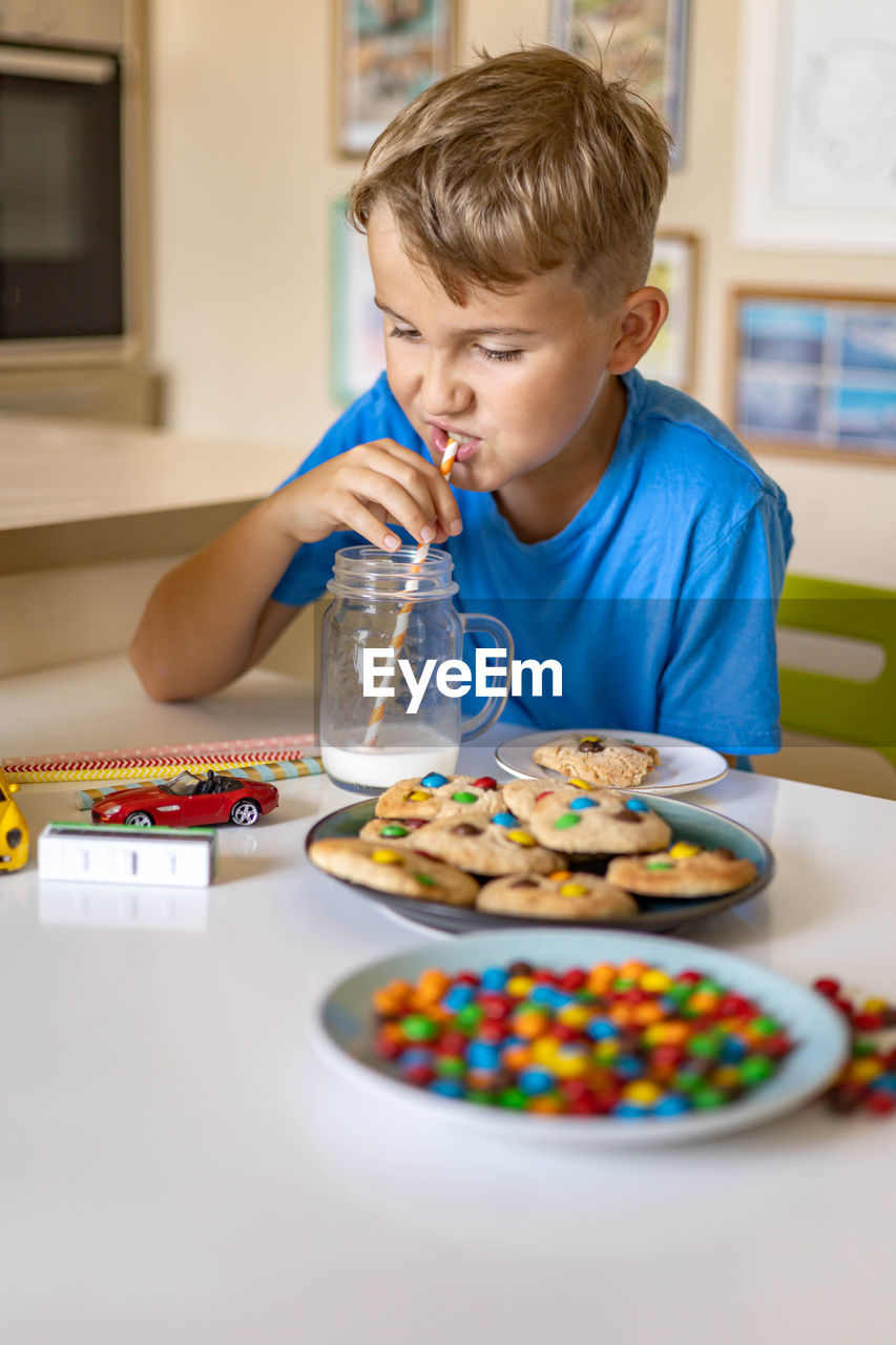 Boy holding ice cream at home