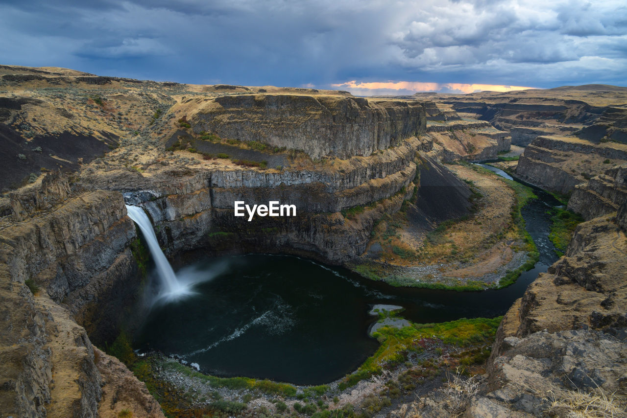 Wide angle long exposure view of palouse falls, washington state with cloudy sky