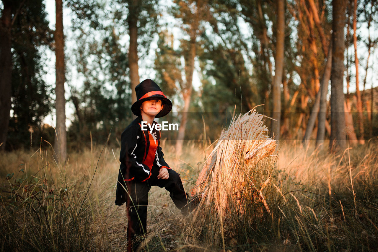 Portrait of boy wearing costume during halloween standing at forest