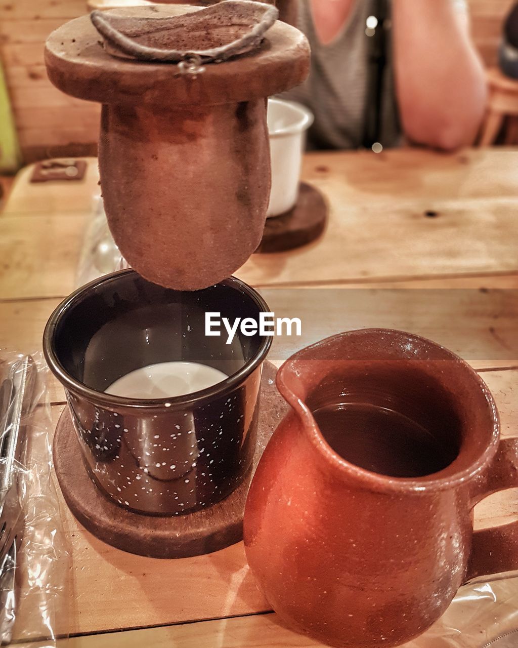 CLOSE-UP OF COFFEE CUP ON TABLE AT HOME