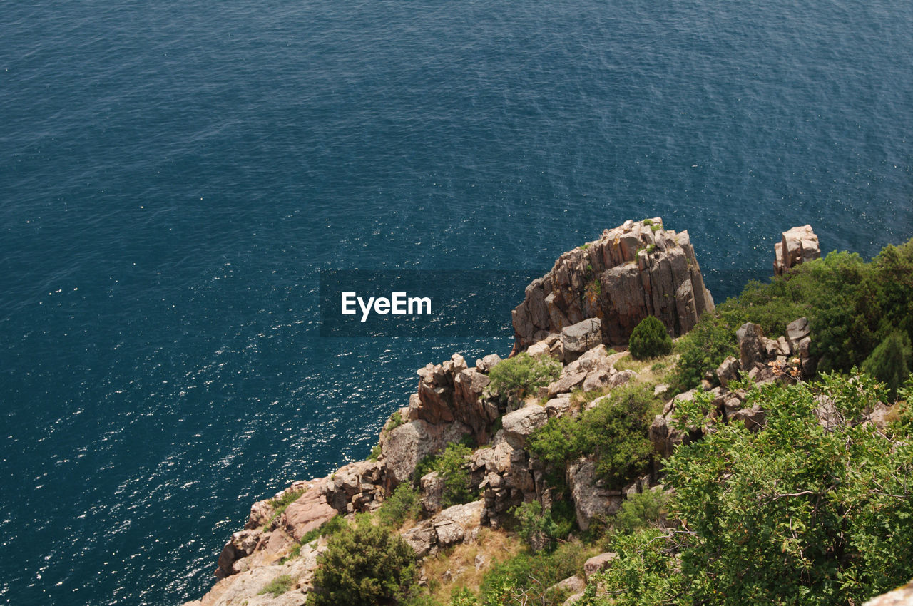 High angle view of rocks by sea