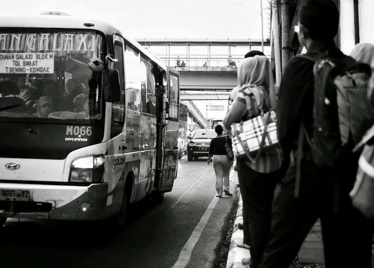 REAR VIEW OF PEOPLE WORKING ON TRAIN