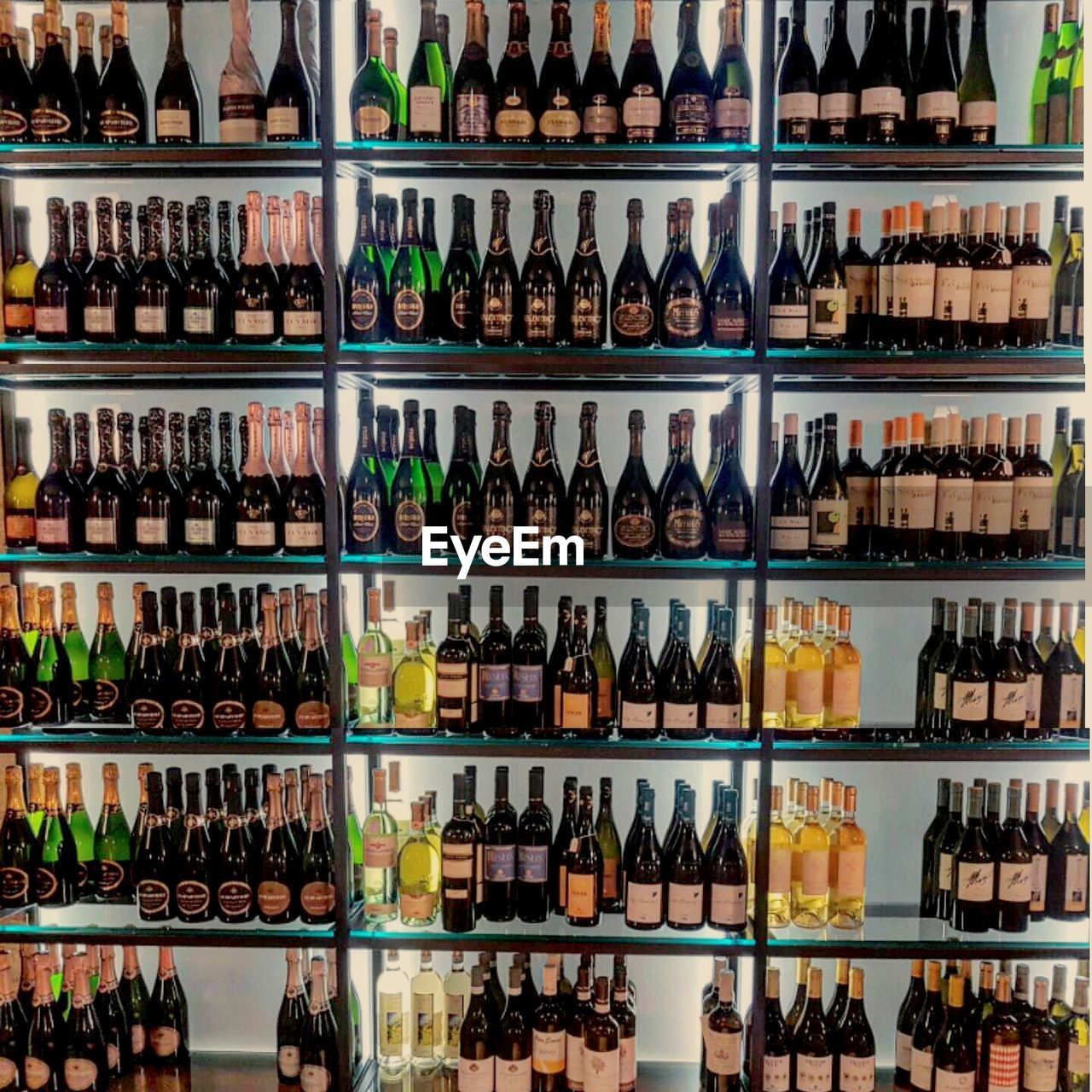 VIEW OF BOTTLES IN SHELF AT STORE