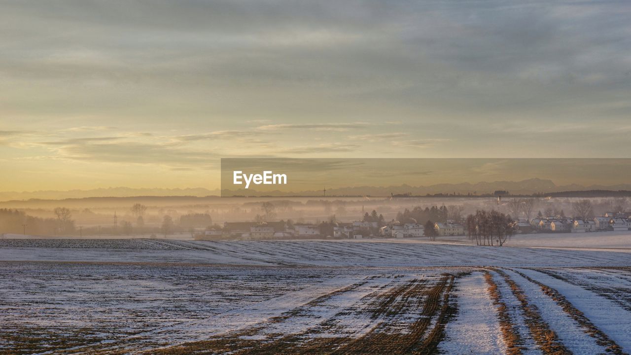 Scenic view of landscape against sky during winter