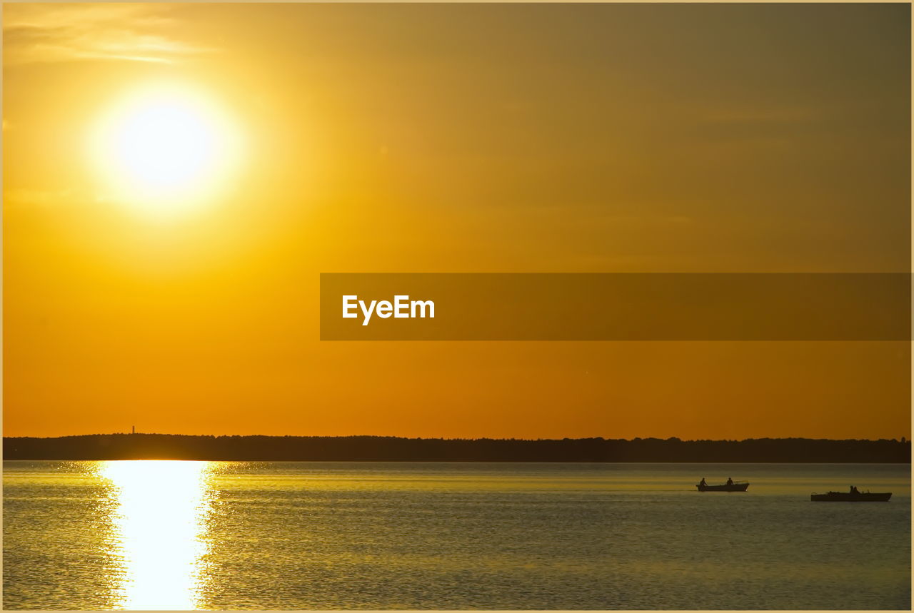 Scenic view of sea against orange sky