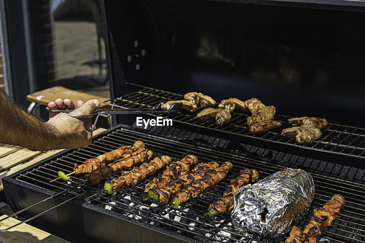 Grilling shashlik on barbecue grill