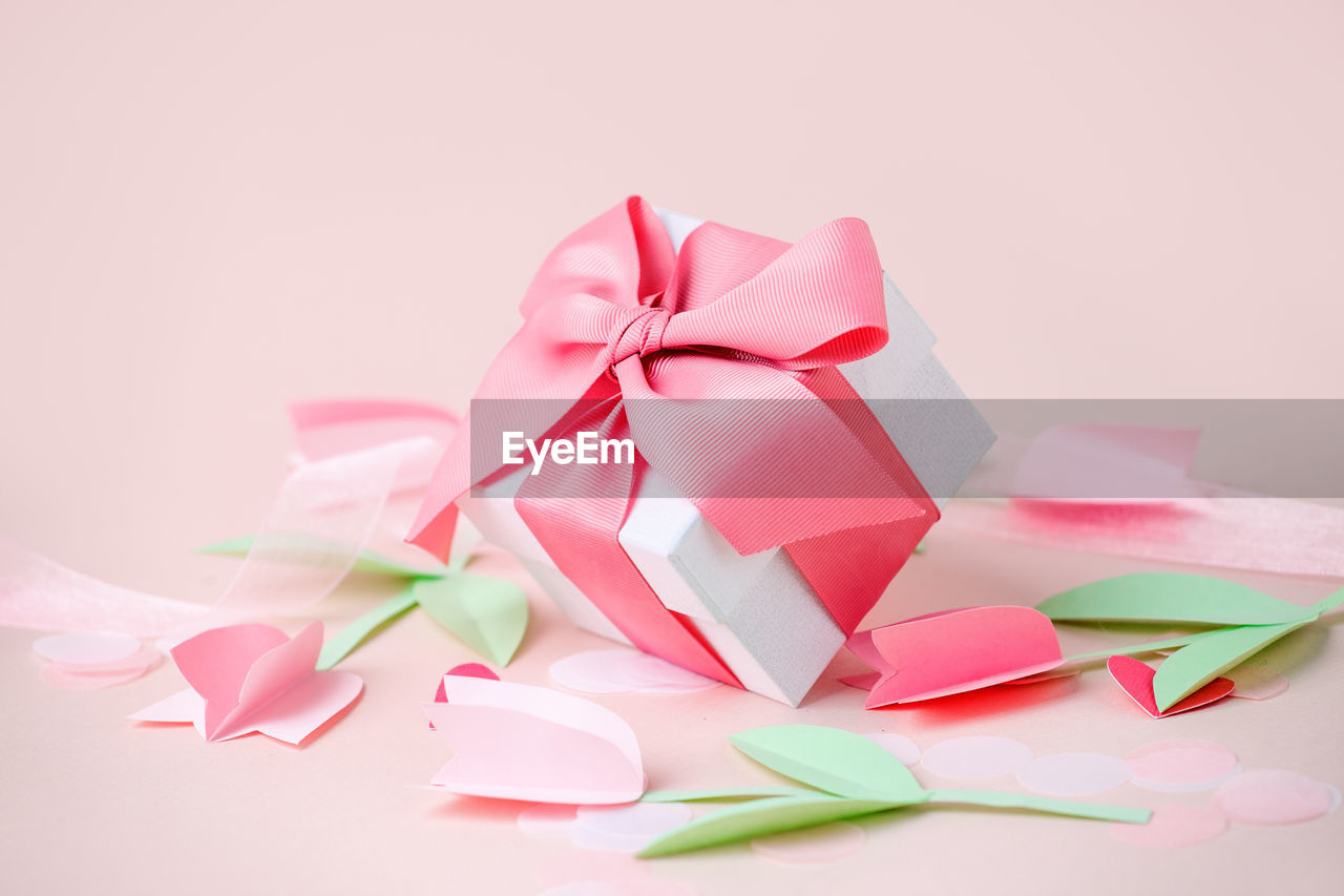 White gift box against pink background