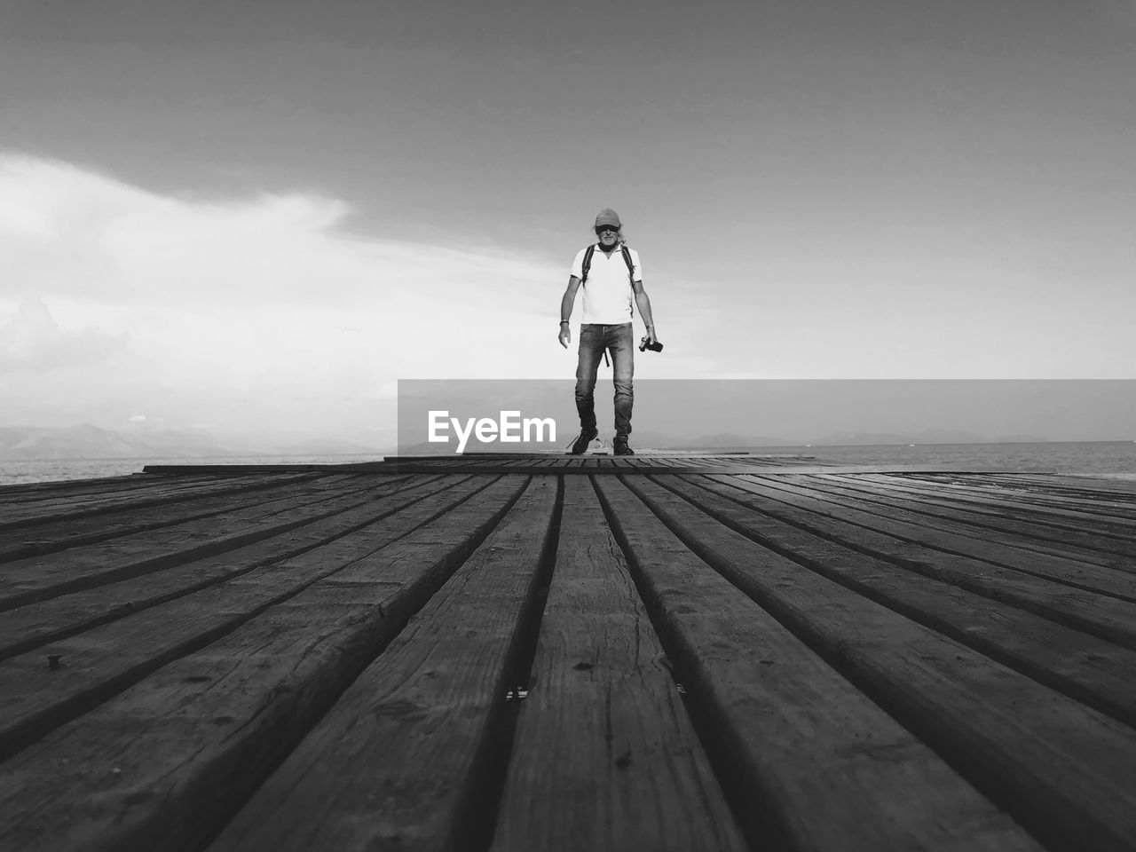 Walk on a pier in Corfu, Greece Adult Blackandwhite Photography Casual Clothing Day Leisure Activity One Person Pier Real People Sky Standing Surface Level Walking Wood - Material Creative Space The Great Outdoors - 2018 EyeEm Awards The Traveler - 2018 EyeEm Awards A New Beginning