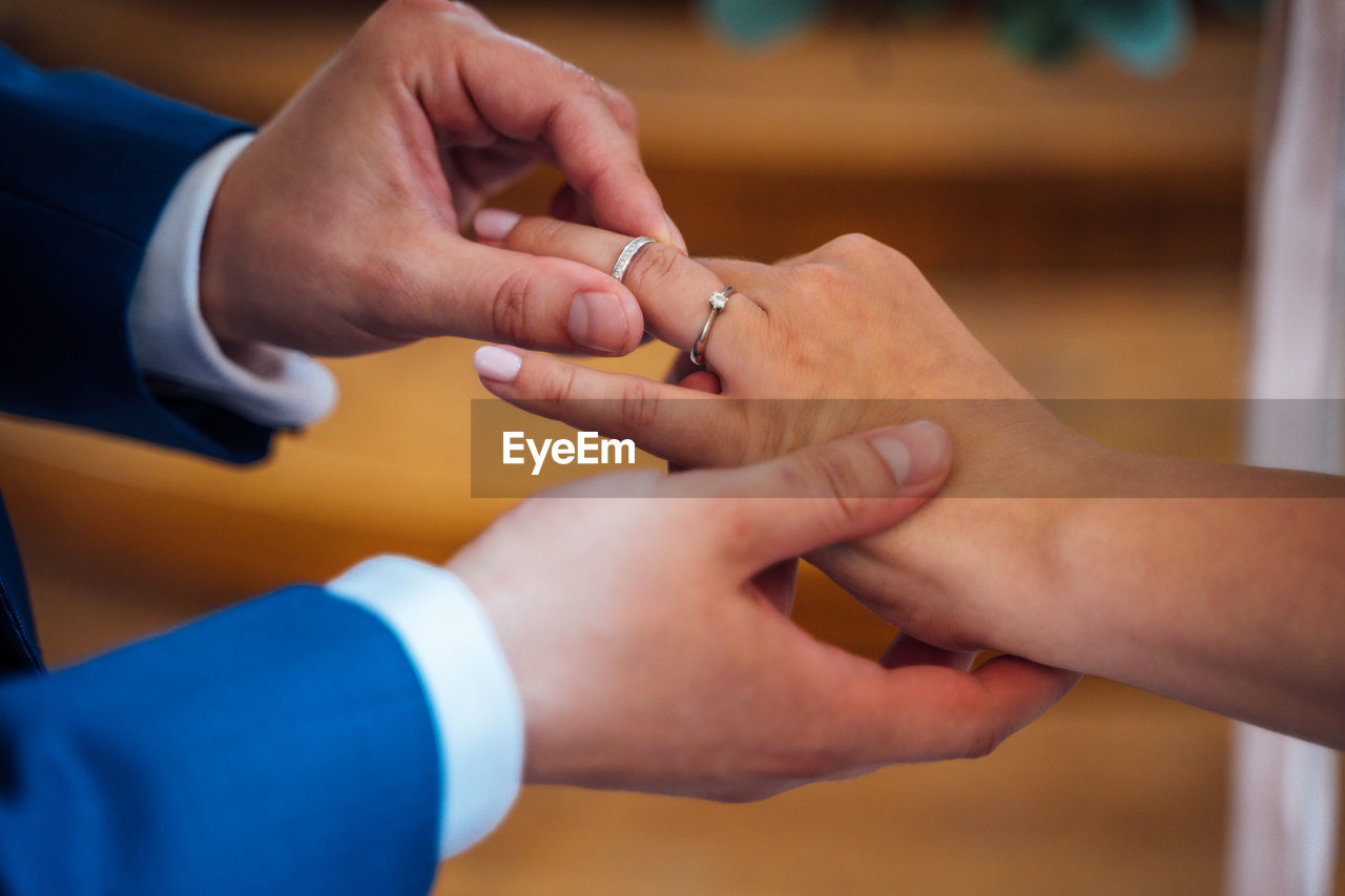 Midsection of couple during wedding ceremony