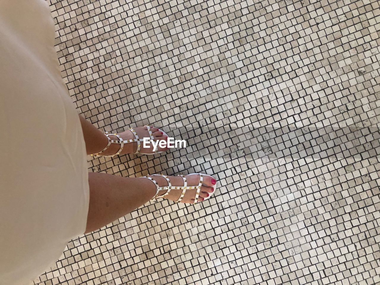 Low section of woman standing on tiled floor