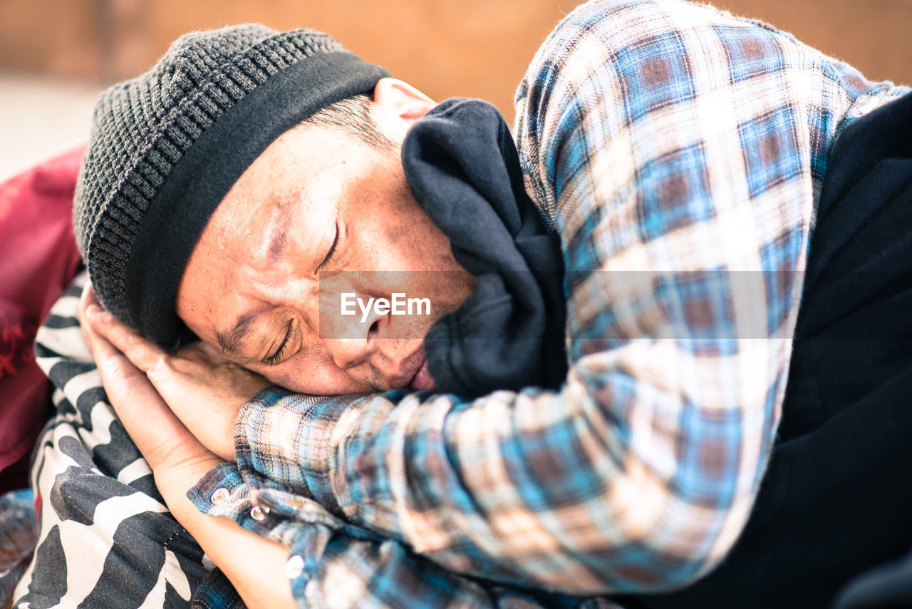 Close-up of beggar sleeping outdoors