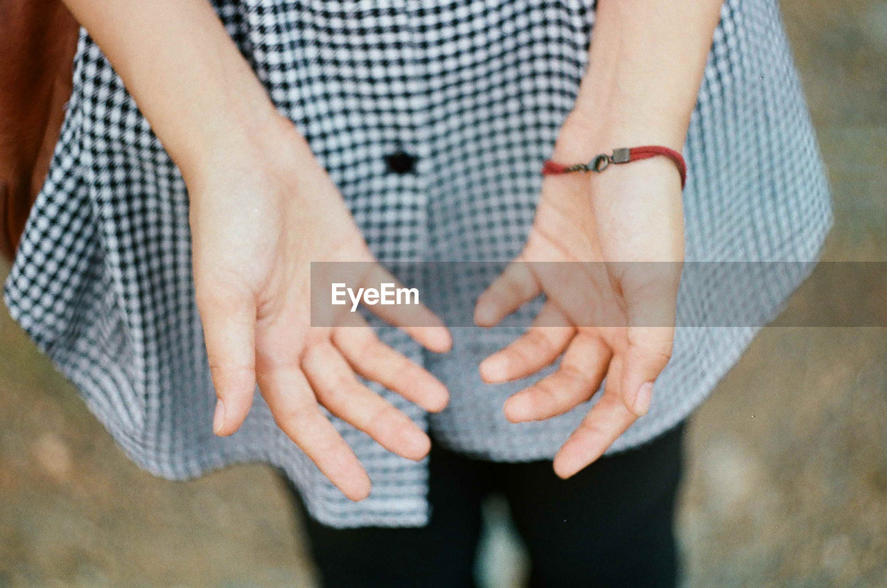 Midsection of woman showing hands