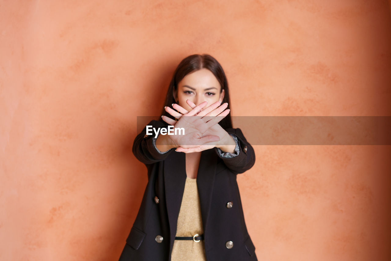 Attractive woman says thank you, but no. beautiful girl in jacket rejecting