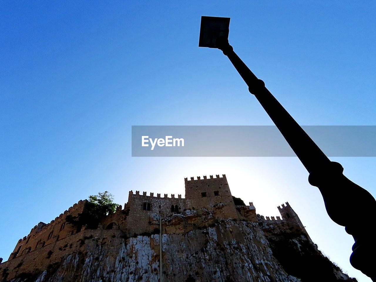 sky, history, architecture, nature, the past, clear sky, blue, low angle view, rock, travel destinations, built structure, outdoors, castle, travel, silhouette, ancient, mountain, fort, day, landmark, building exterior, no people