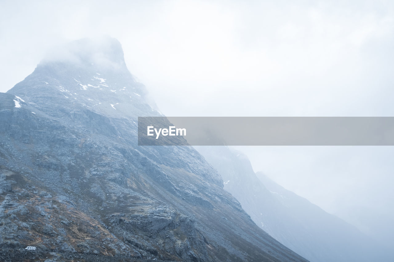 Jagged mountain peak with misty top and background. norway.