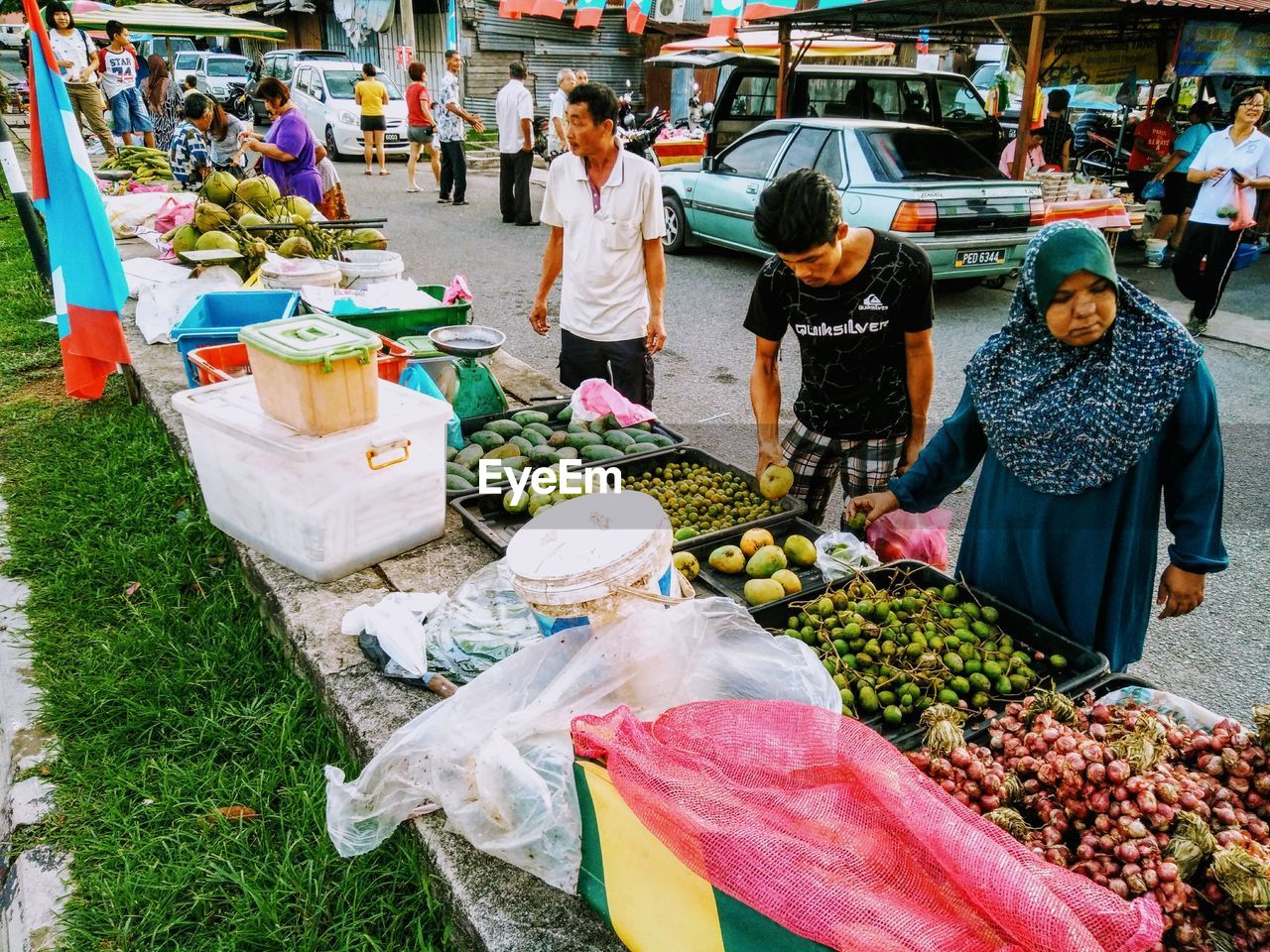 PEOPLE AT MARKET STALL