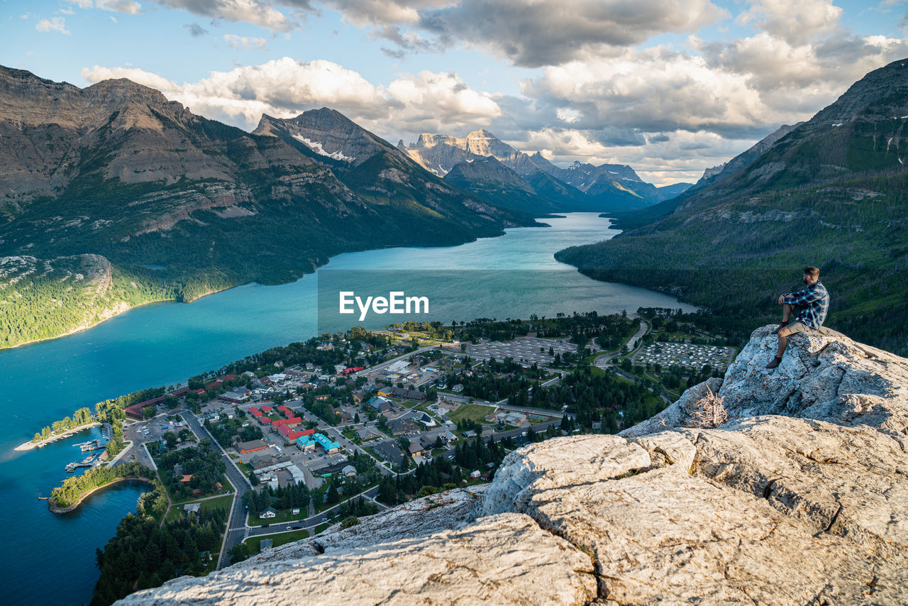 Hiker watching the sunset over waterton national park in alberta