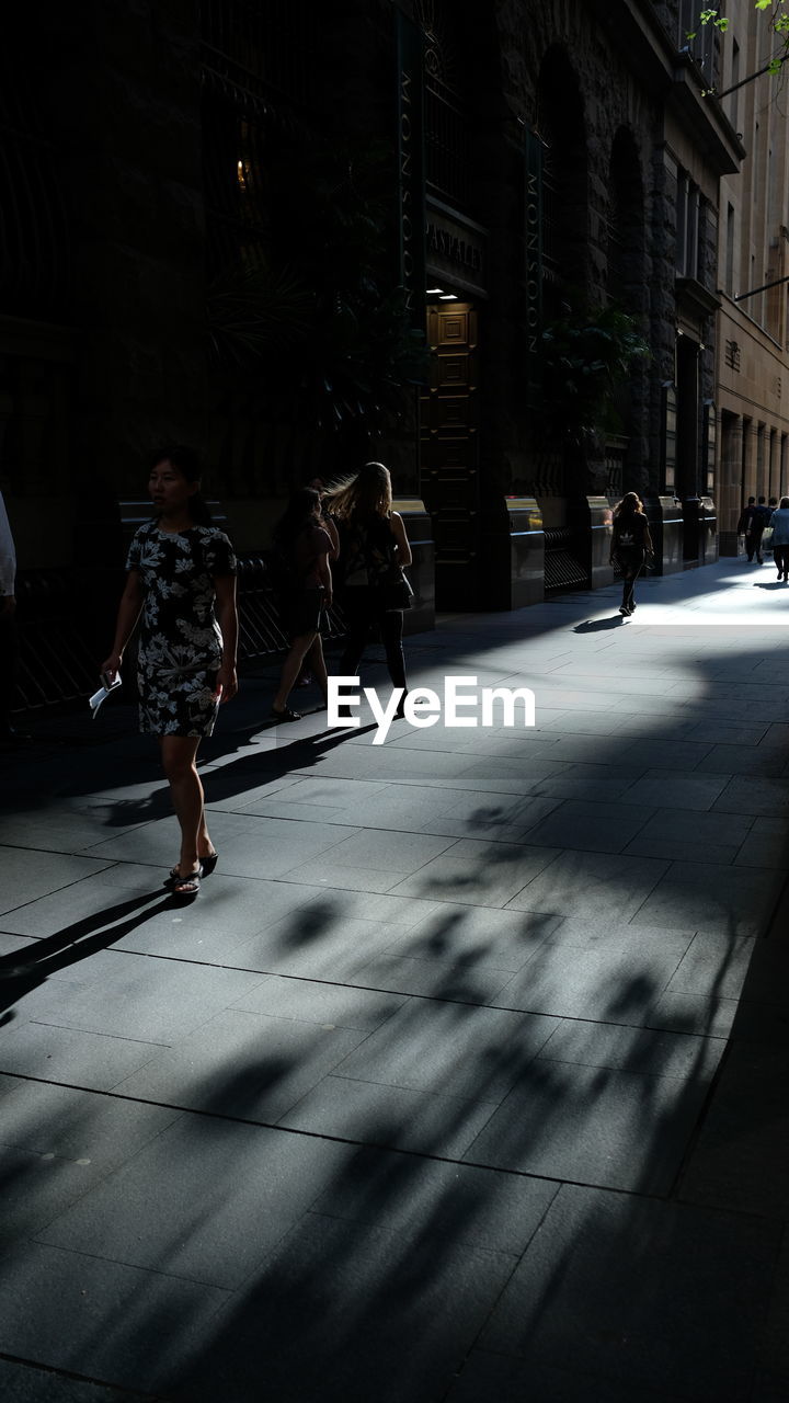 PEOPLE WALKING ON STREET IN CITY