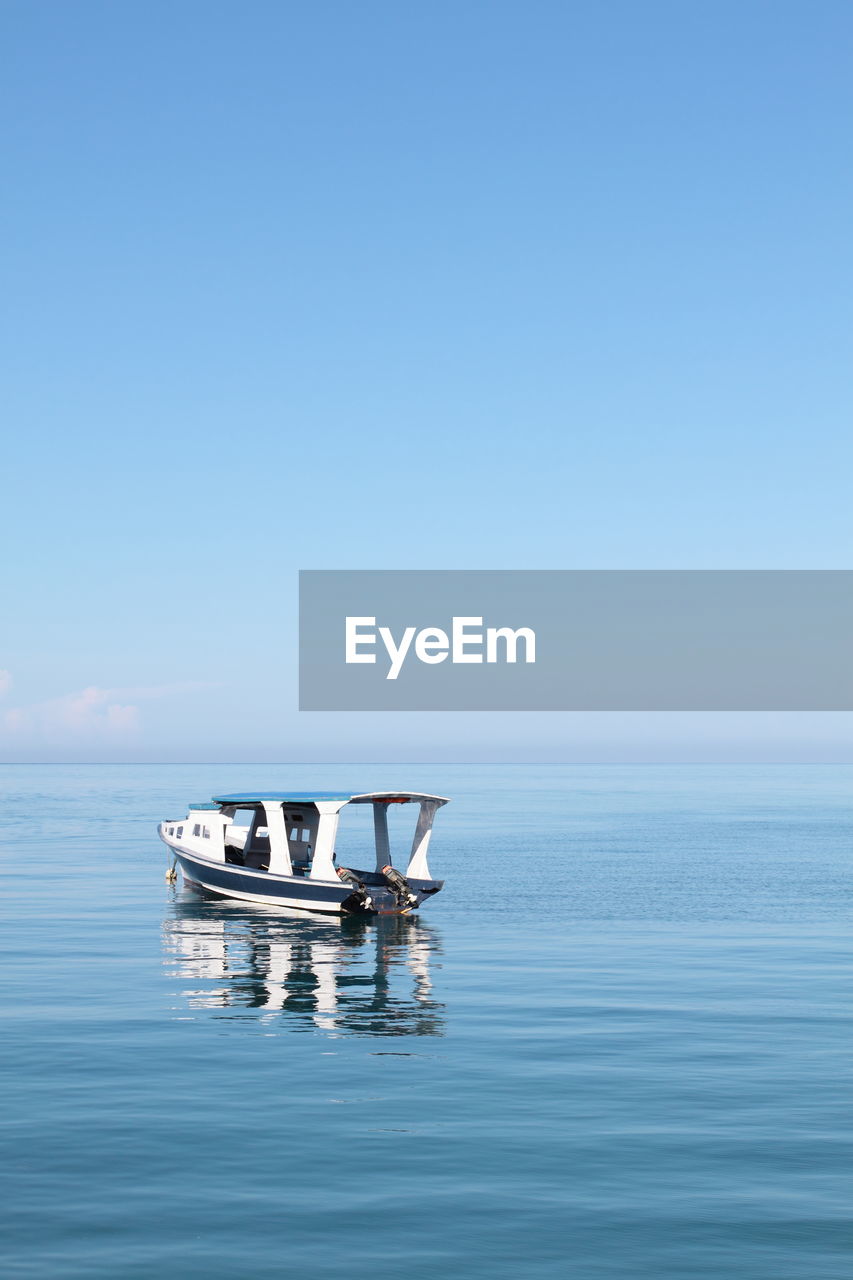 An empty motor boat in sulawesi sea against clear sky