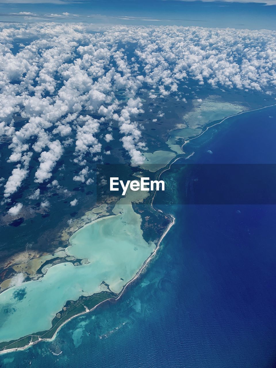 Aerial view of island amidst sea against sky