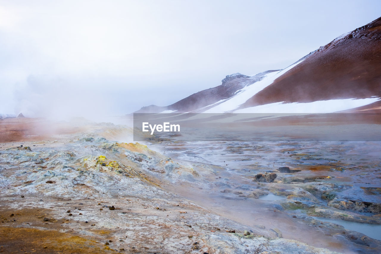 scenic view of waterfall in foggy weather