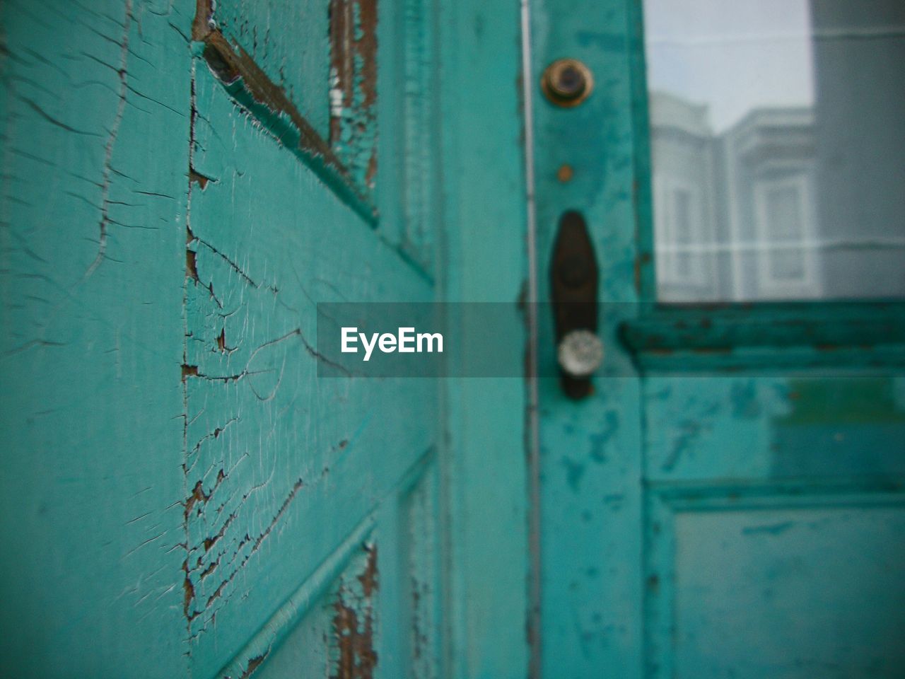 Close-up of green old wooden house door