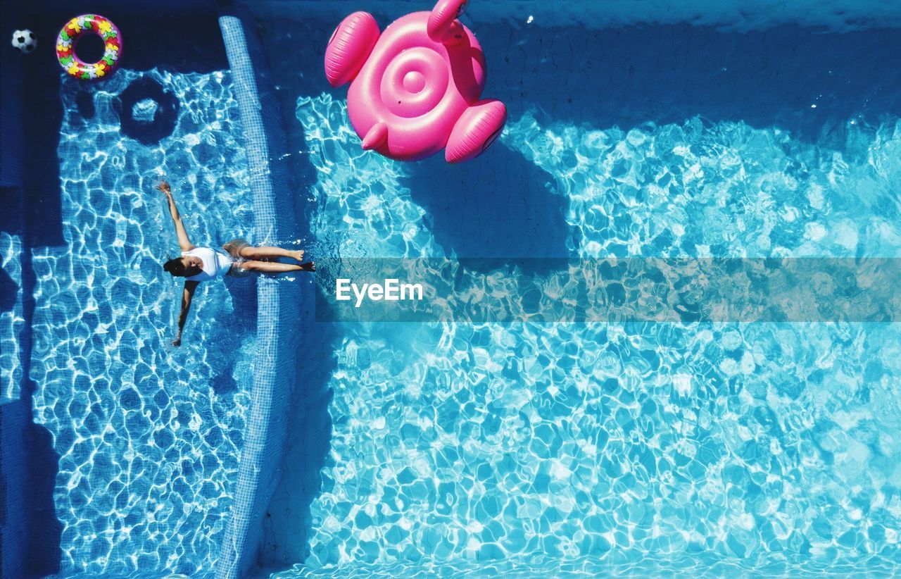 High angle view of woman swimming in pool