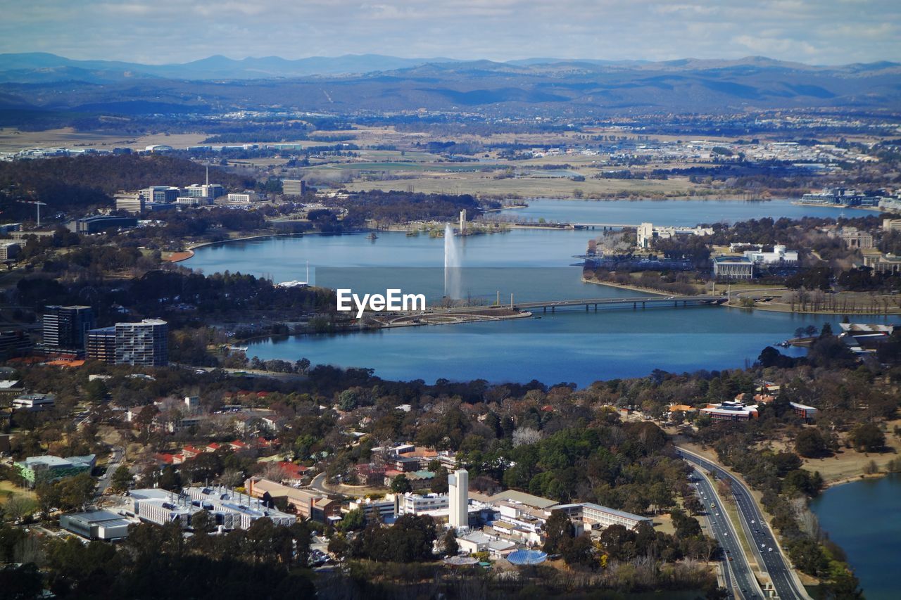 High angle view of townscape by river against buildings