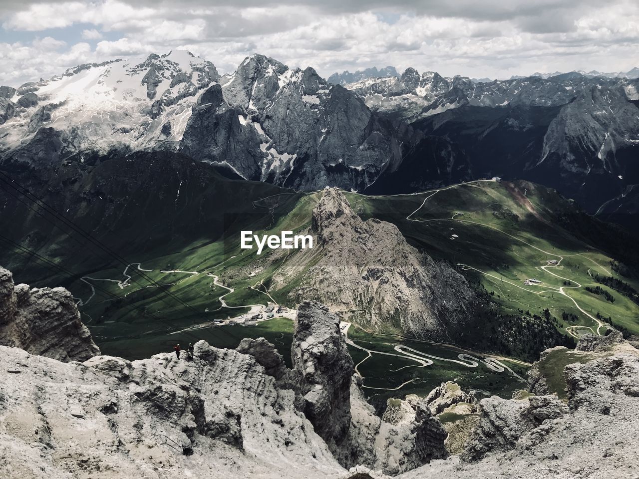 Aerial view of land and mountains against sky