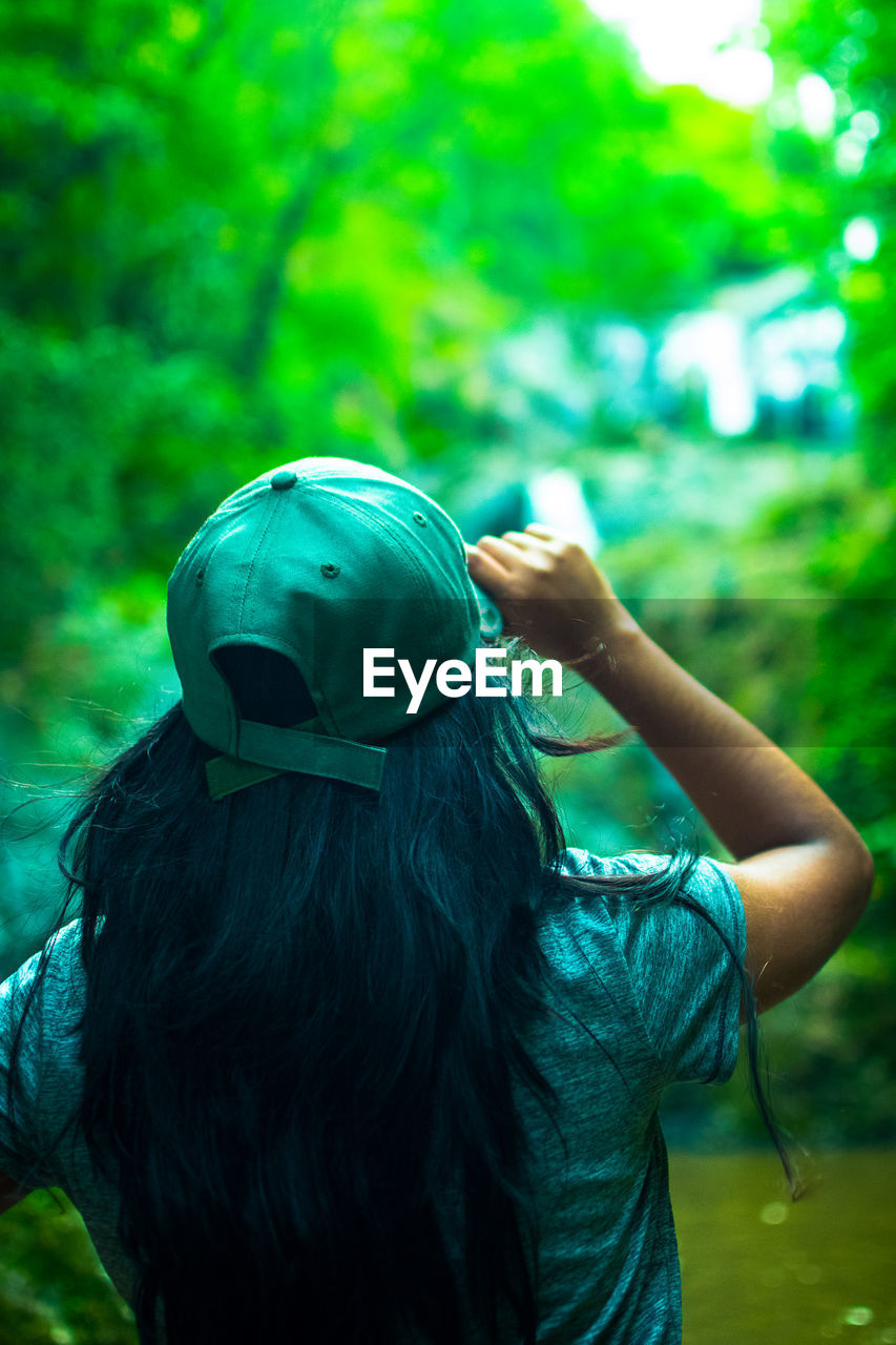 Rear view of woman wearing cap while standing outdoors