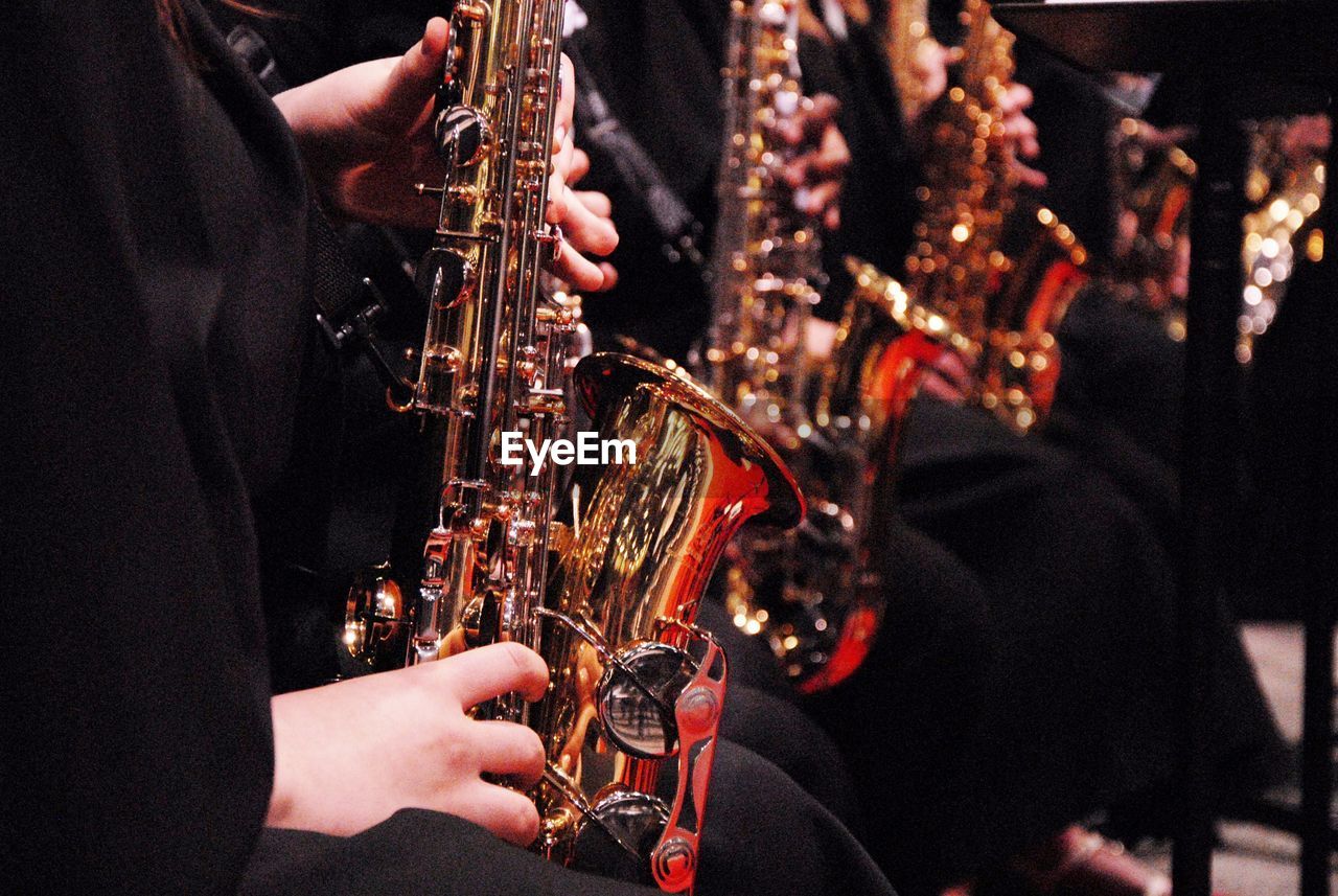 Cropped image of musician playing saxophones