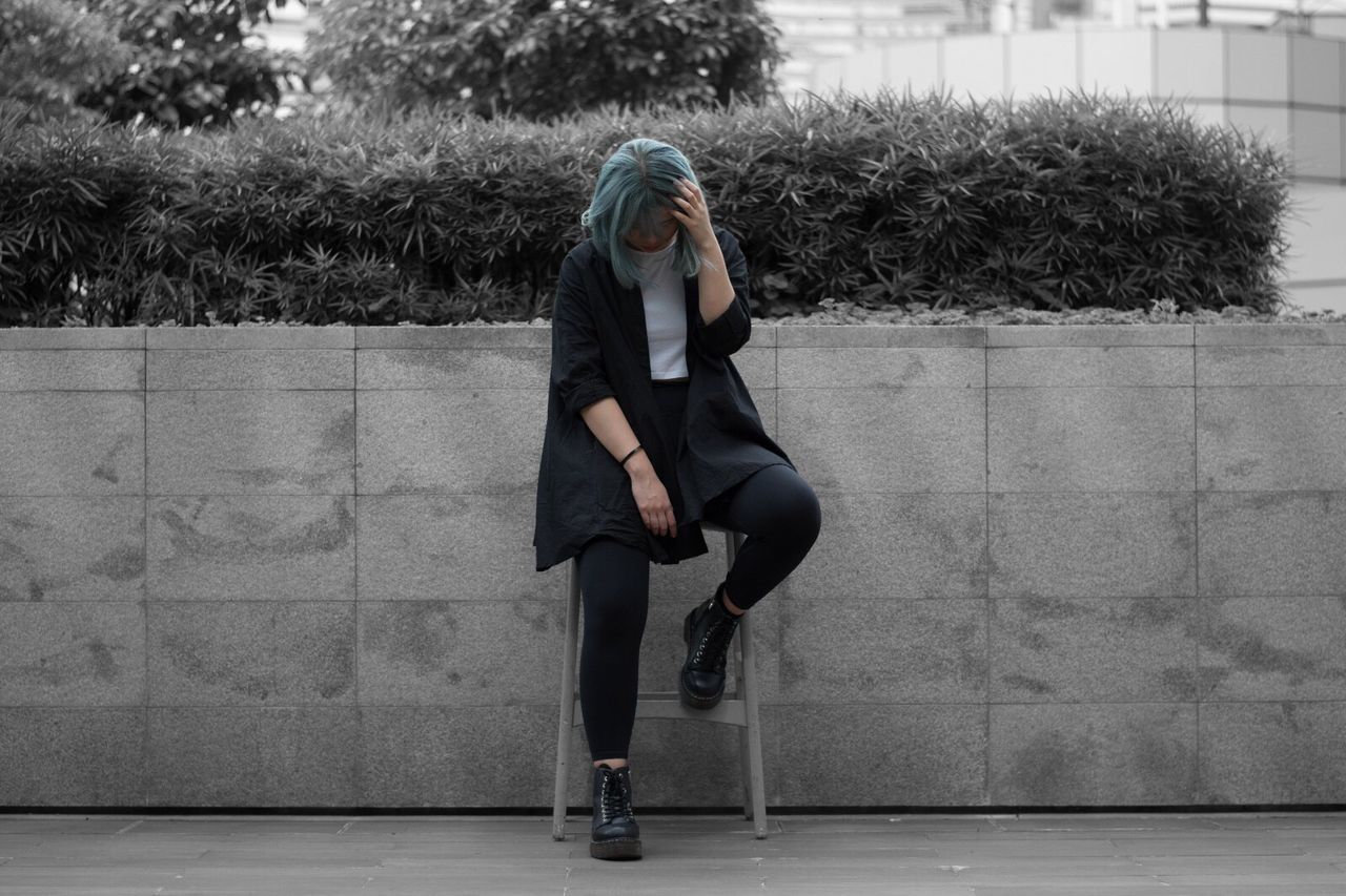 Young woman sitting outdoors