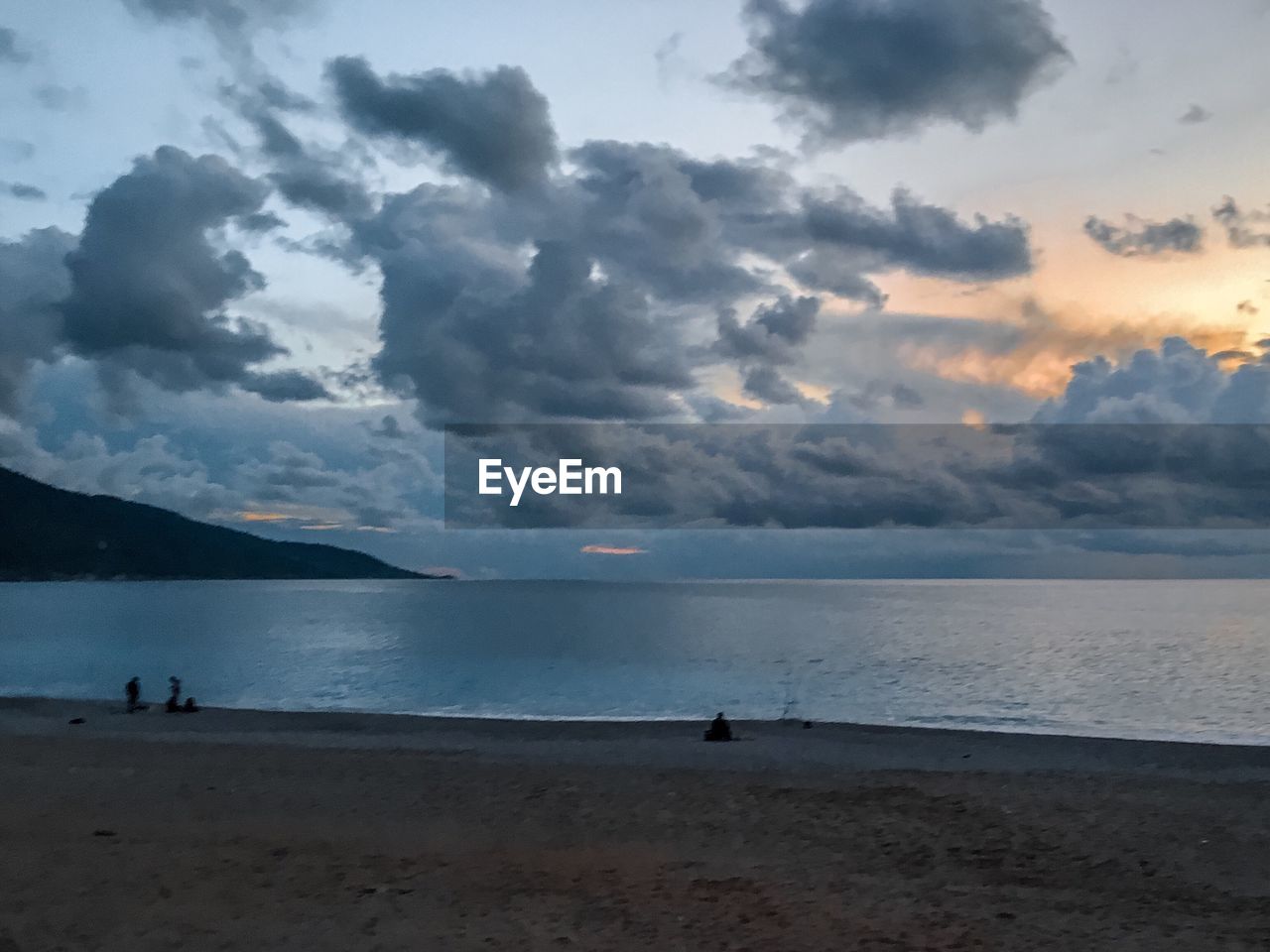 SCENIC VIEW OF BEACH DURING SUNSET