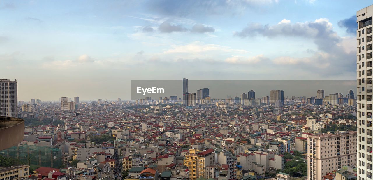 Aerial view of modern buildings in city against sky